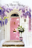 The photograph portrays a welcoming Hatton entrance, where pastel tones and abundant flowers combine to tell a story of new beginnings. At the centre stands a pale pink front door, its gentle colour creating a warm contrast against the surrounding whitewashed walls. The surface of the door looks freshly painted and smooth, hinting that this home might be newly claimed by its owners, perhaps tucked along a quiet street beyond the main airport routes. Framing the top of the doorway, wisteria drapes in soft, lavender cascades, the pendulous clusters of blooms overlapping to form a loose, natural arch. Their delicate purple tones and imagined fragrance add a dreamy, almost storybook quality to the scene. Resting neatly on the threshold below is a rustic-style grey bucket filled with a luxurious arrangement of roses. These roses are creamy white and soft ivory, each bloom generously layered, their petals curving outward in full, rounded shapes that speak of freshness and careful handling. Interwoven with the roses are muted green leaves and sprigs of foliage, which lend contrast and texture without overwhelming the calm palette. Around the bucket's base, a satin ribbon in light blush pink is tied into a tidy bow, subtly catching the light and linking visually back to the colour of the door. Soft daylight filters through the hanging wisteria, creating gentle patches of shade and brightness that animate the doorway. The scene feels like a quiet, heartfelt welcome-a housewarming arrangement or congratulations bouquet delivered to Hatton, standing ready on the step to greet its new owners with understated elegance and floral comfort.